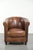 This characterful sheepskin club chair has developed a beautiful patina over the years and is finished with decorative...