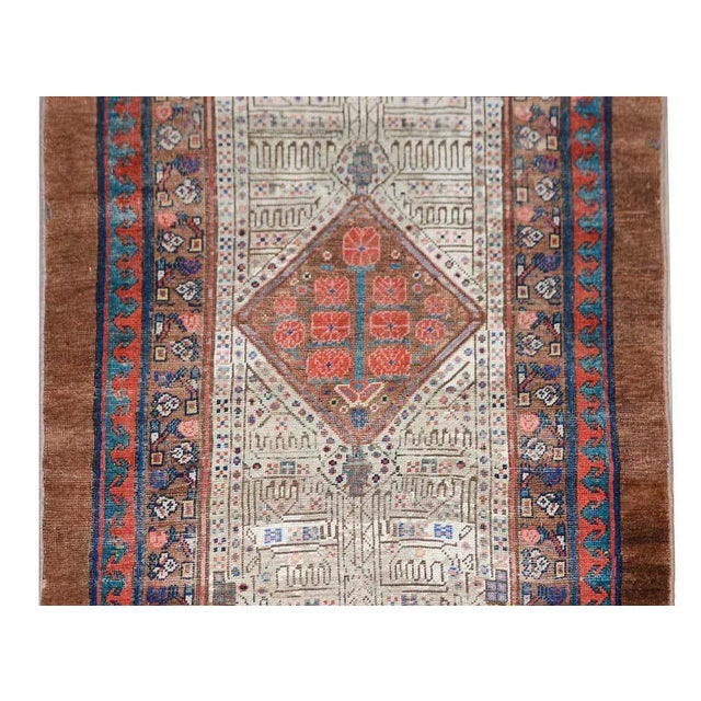 An incredible early 20th century Persian Serab runner with the most wonderful stylized floral patterned field with three...
