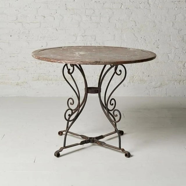A breathtaking 19th century Belgian round table, pairing a magnificent original circular marble top with an elegantly...