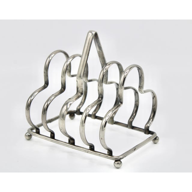 Fine quality English silver-plate toast rack. This charming 4 slice rack can also double to hold letters and mail as a...