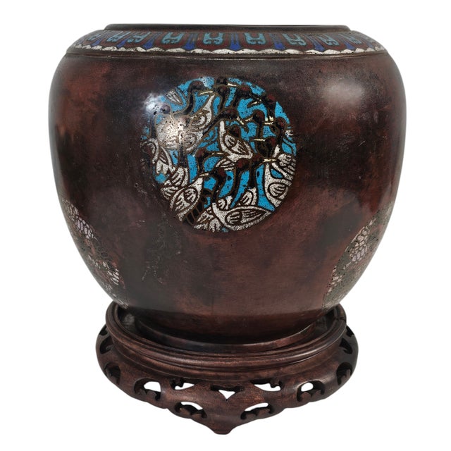 A masterwork of form and ornamentation, this antique Japanese bronze vase embodies the refinement of Meiji-era metalwork....