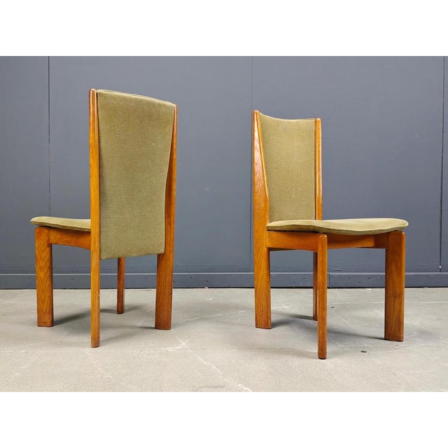 Vintage wooden dining chairs with an olive green velours upholstery. Nicely crafted high quality wooden frames. The soft...