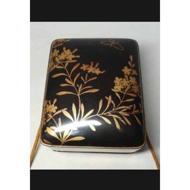 Lacquered presentation box from the Edo period. Black lacquer decorated with a fine gold 'princess' maki-e taking months...