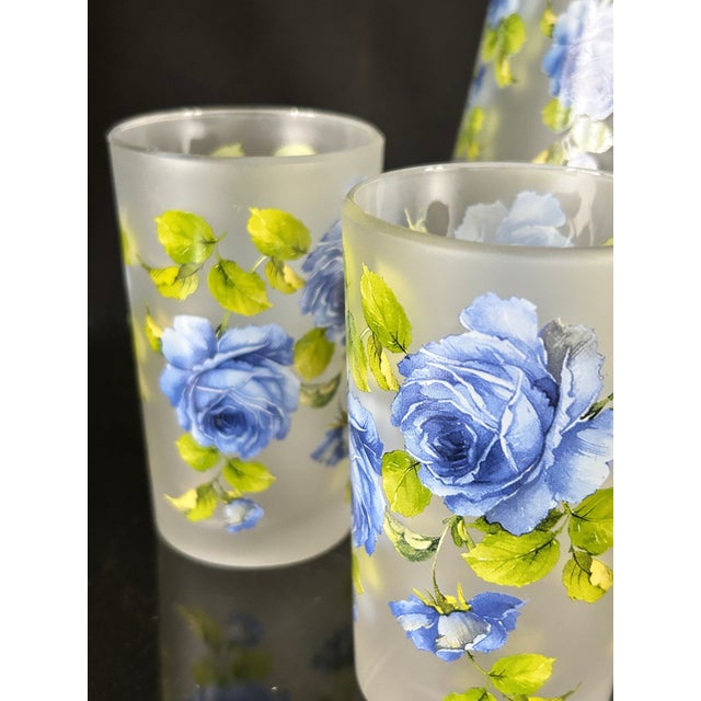 This is a beautiful set of vintage glassware. It is a drink pitcher and 2 glass set made from frosted glass and adorned...