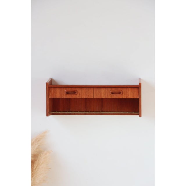 This authentic vintage teak wall console is the centerpiece your interior décor has been missing. If you're looking for a...
