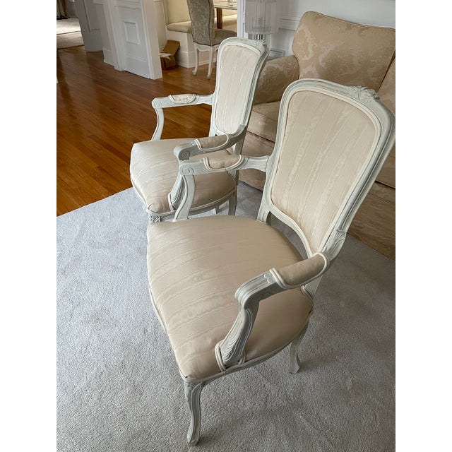 Add glamour to any room with these newly upholstered French Bergere arm chairs. Newly upholstered in champagne silk...
