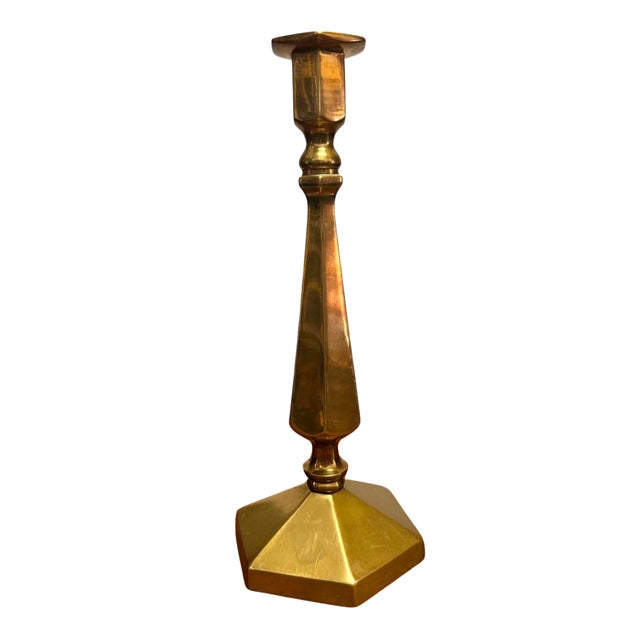 A striking vintage solid brass candlestick distinguished by its crisp geometric silhouette and elegant architectural...
