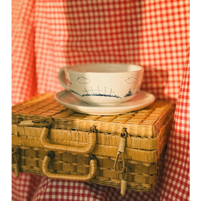 This vintage-inspired picnic basket, crafted in the Netherlands from rattan, features wicker handles and a sturdy...