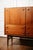 This 1960s teak bar cabinet embodies the tradition of post-war Scandinavian design. Its tapered legs, recessed circular...