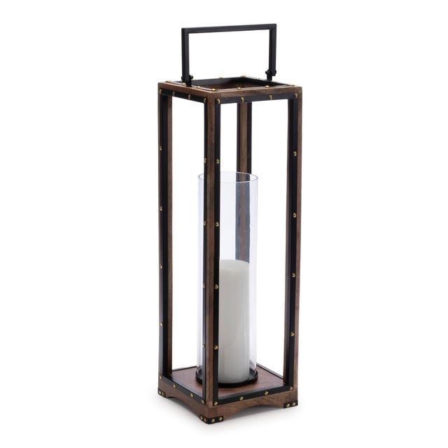 Elevate your home decor with the Tall Framed Candle Holder with Glass Hurricane & Rivet Accents. This 25.25-inch statement...