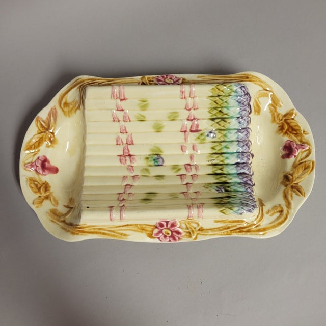 Antique French majolica asparagus serving dish, circa 1900, with a raised molded asparagus cradle, hand-painted floral...