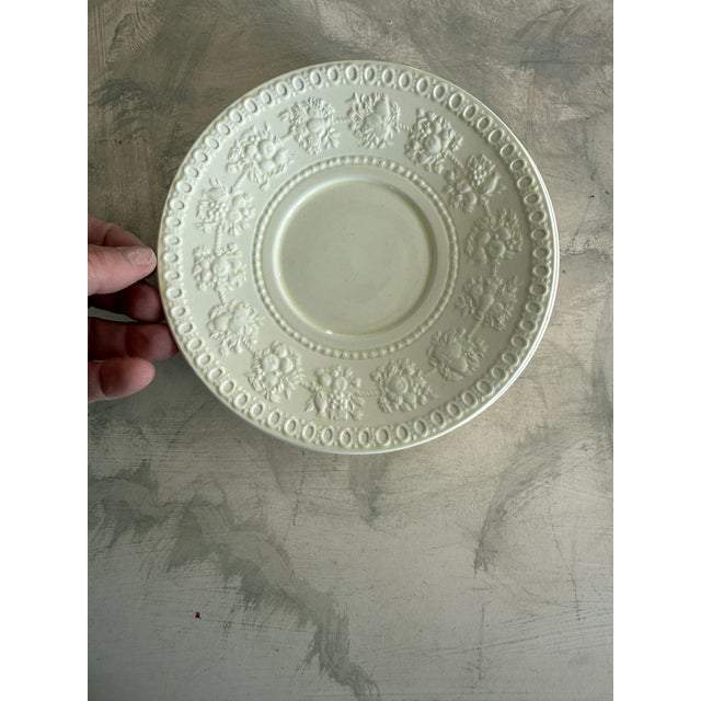 A refined set of six 7 inch plates in the classic Wellesley pattern by Wedgwood, made in England. These elegant cream-...