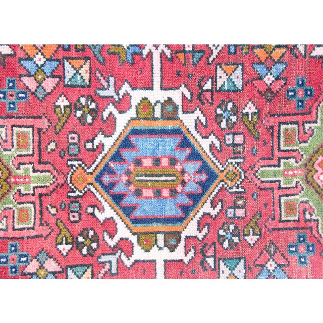 A charming early 20th century Persian petite hand knotted Heriz rug with three large stylized floral medallions living...