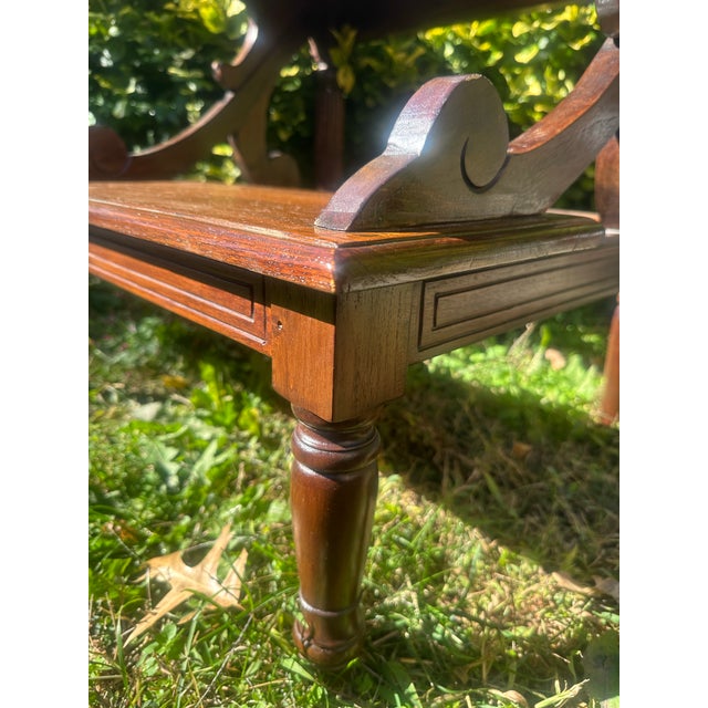 An elegant pair of Victorian-style mahogany library steps featuring two fixed wooden treads, beautifully shaped scroll...