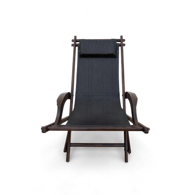Folding hammock in solid wood and black leather with a safari-style headrest, 1950s. The hammock allows for a gentle...