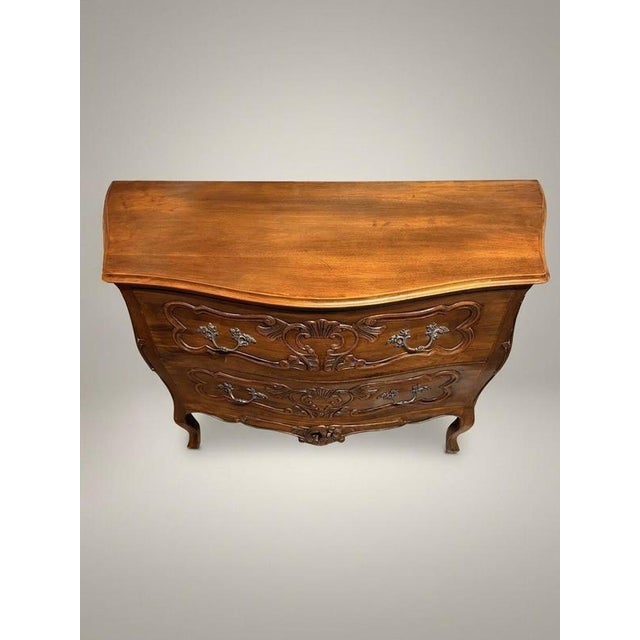Bring timeless European elegance to your interior with this mid-20th-century Italian walnut Bombe chest of drawers....