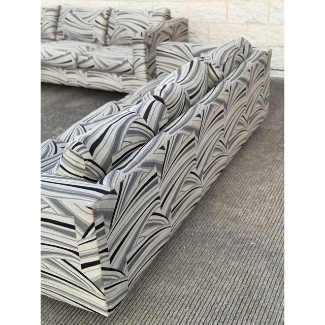 Late 20th-century tuxedo three-seat sofa. Features a bold black, white, and gray abstract-patterned upholstery. Designed...