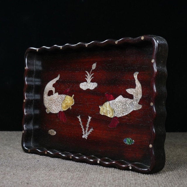This is a beautifully crafted rectangular wooden tray featuring intricate mother-of-pearl (nacre) inlay and a...