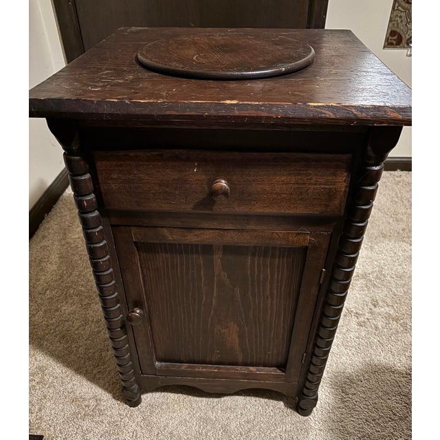 Antique Empire side table with drawer, door and spinning top. Well made of solid cherry with intricate column side accents.