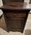 Antique Empire side table with drawer, door and spinning top. Well made of solid cherry with intricate column side accents.