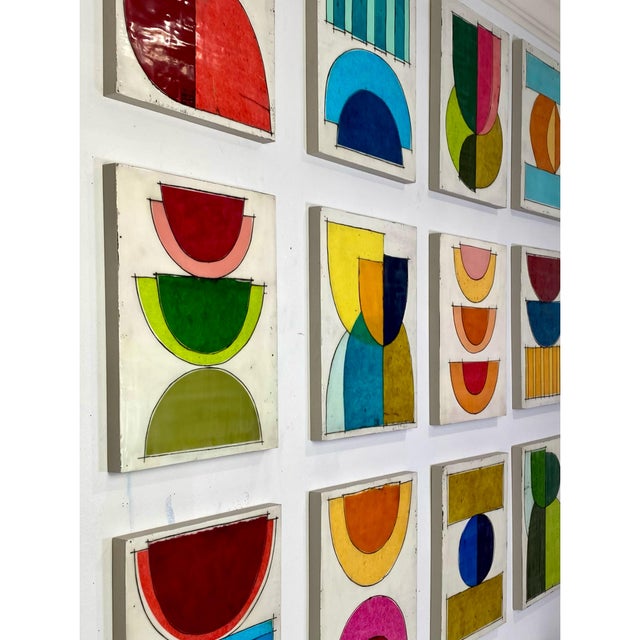 Twelve 14×11 cradled wood panels make up this encaustic mixed media art piece. In the photo they are hanging spaced...