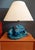Table lamp made of enameled ceramic depicting two blue/blue koi carpes (dimensions of l40 x w43 x h35 cm). The support of...