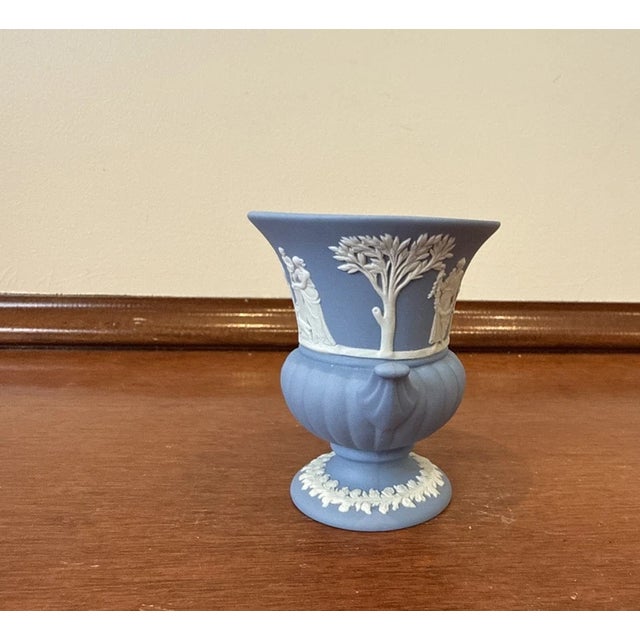 Beautiful vintage Wedgwood blue Jasperware mini Grecian-style vase/urn. This elegant collectible piece features the...
