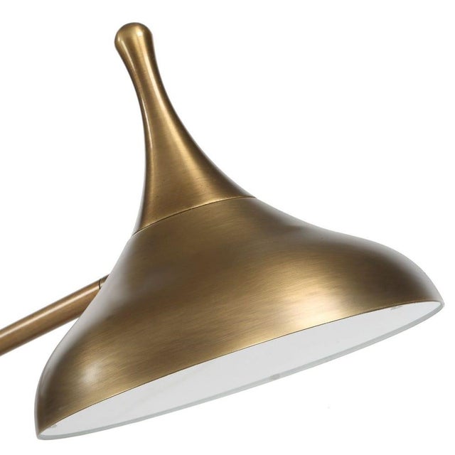 Blending sculptural elegance with functional design, this adjustable arm desk lamp pairs the rich, dark tones of an...