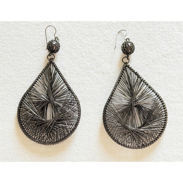 Vintage oversized statement earrings featuring elongated teardrop frames wrapped and woven with hundreds of fine metallic...