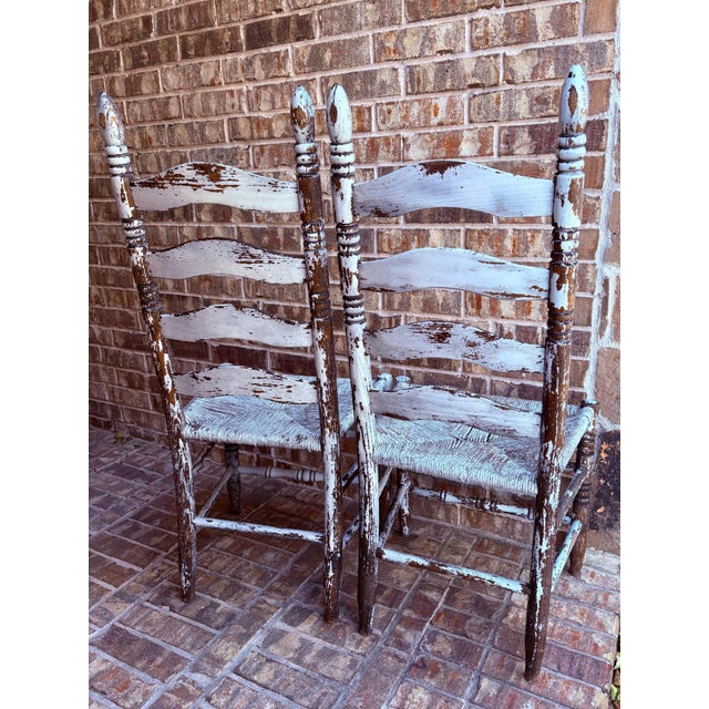 White Pair of Early 20th Century Rush Seat Ladderback Side Chairs With Distressed White Chippy Paint Finish For Sale - Image 8 of 12