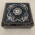 Black chinoiserie papier-mâché box. Lovely detailed top inlaid with mother of pearl. Gilt painted details on top and...