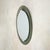 An Italian wall mirror from the 1960s, attributed to Max Ingrand for Fontana Arte. The oval silhouette is simple and...