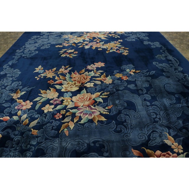 Hand-knotted in wool and originating from China circa 1920-1930, this 12x13 antique Chinese Art Deco rug is a rare...