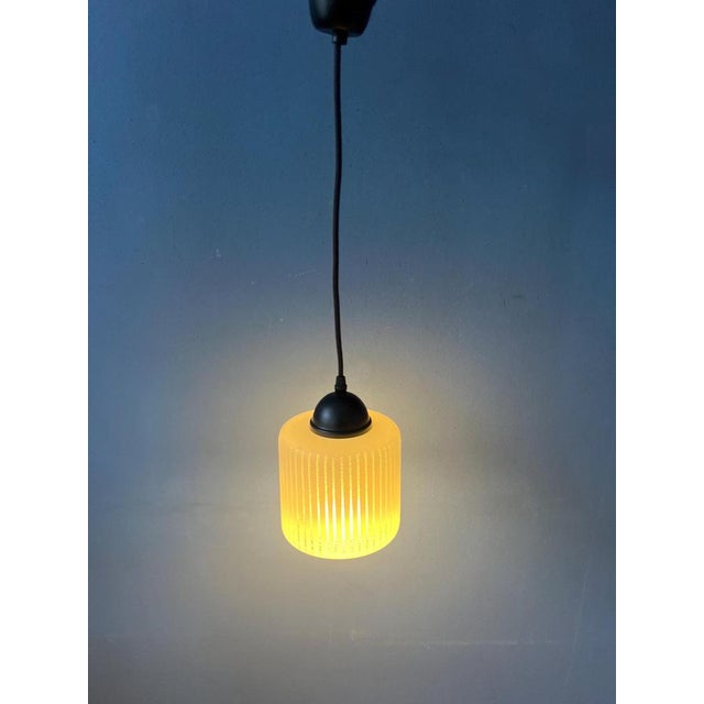 Small and cute can-shaped glass pendant lamp with stripe pattern. The light escapes beautifully through the glass...