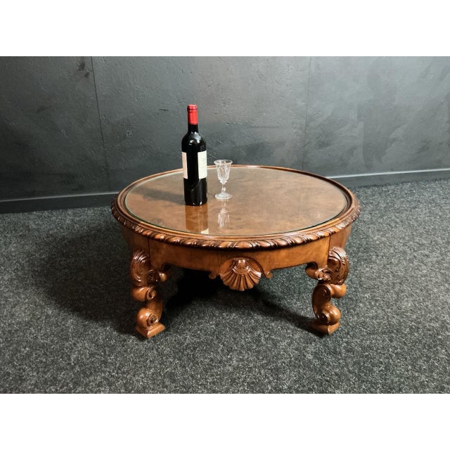 Round coffee table with Burr Walnut top Plate glass top present