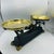 Antique English Iron Scale with two brass trays. The black and gold scale has casted in the frame Lorre on one side and...