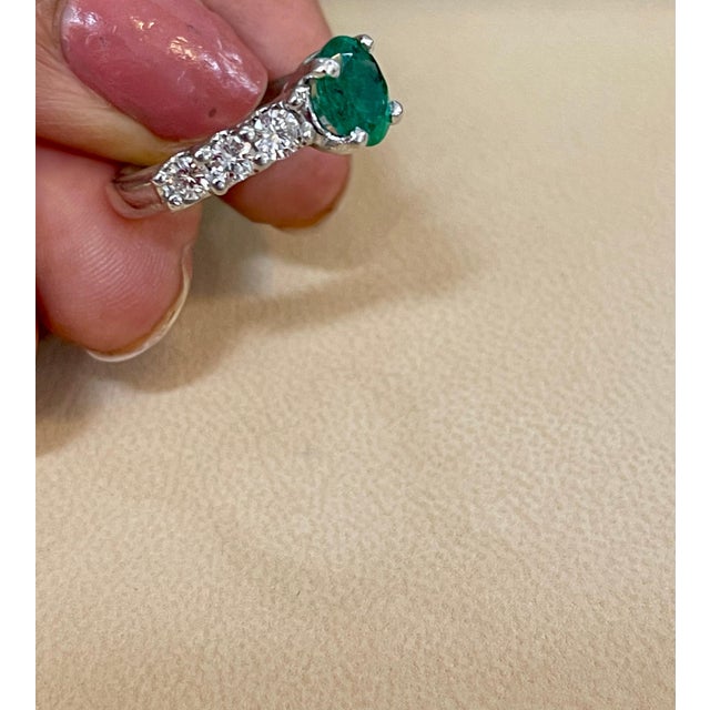 Approximately 1.25 Carat Oval Cut Emerald and approximately 0.90 Carat Diamond Ring Platinum Size 5 A classic design ring...