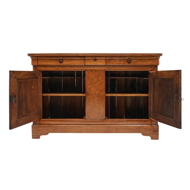 Buffet or credenza in the Louis Philippe style from France. It is made of solid wood construction, primarily walnut. It...