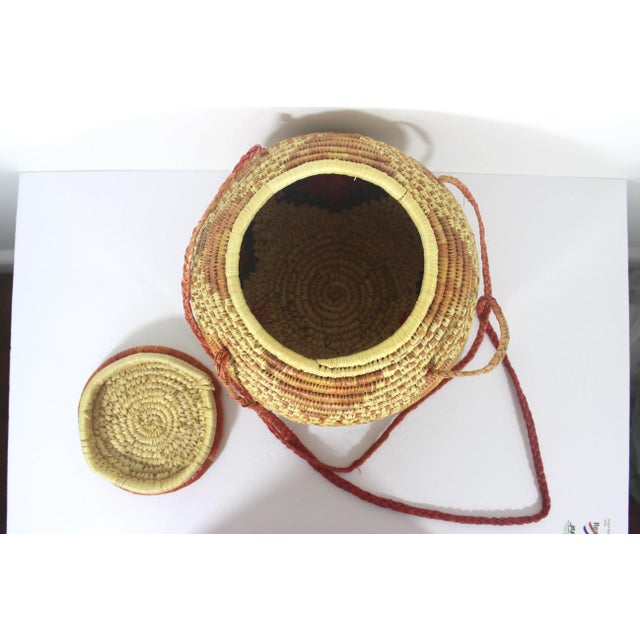 African Vintage African Coiled Straw Lidded Two Tone Orange Hand Woven Covered Basket With Straps For Sale - Image 3 of 10