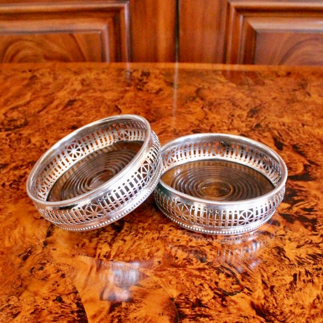 A very fine pair of English silver plate wine coasters, the convex fretwork bodies with attractive pierced fluting and...