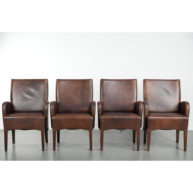 We are offering this set of 4 beautifully finished dining chairs/side chairs with armrests, made of cowhide leather. This...