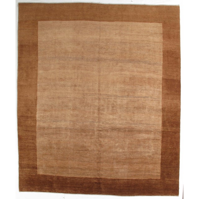 Hand-knotted Persian Gabbeh rug featuring a bold, minimalist field with a contrasting border. Gabbeh rugs, traditionally...