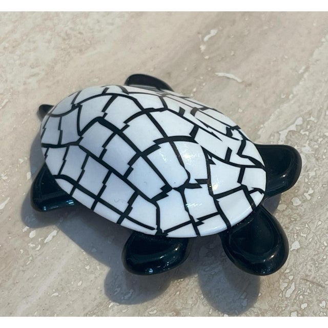 This vintage tortoise brooch is crafted from layered cellulose acetate, the shell built up in a dense, cracked-ice mosaic...