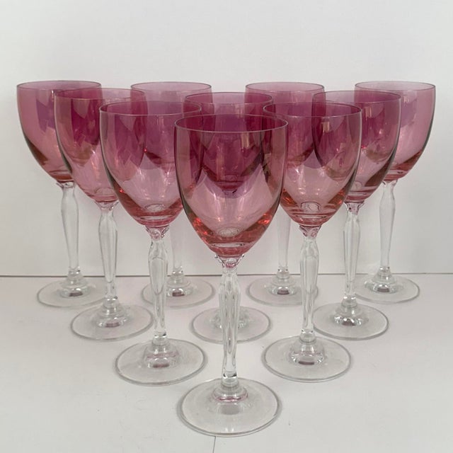 1960s pink wine glasses on transparent baluster stems with flower petal decoration where stem meets bowl. Mold-made. The...
