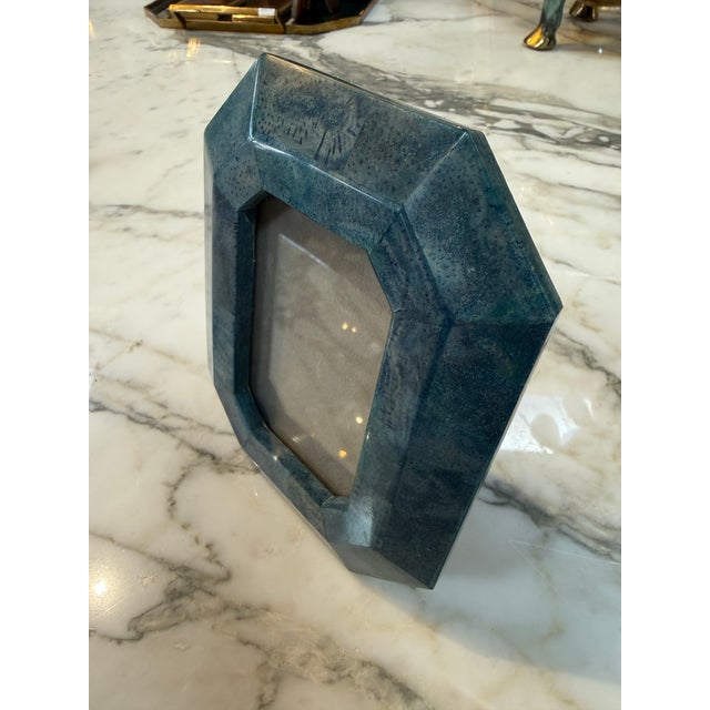 Distinctive vintage Italian photo frame crafted with a deep blue lacquer finish. The frame features a bold faceted...