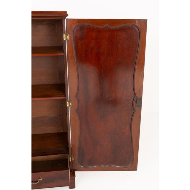 A fine Georgian-style mahogany hall cabinet of elegant proportions, raised upon traditional bracket feet The cabinet...
