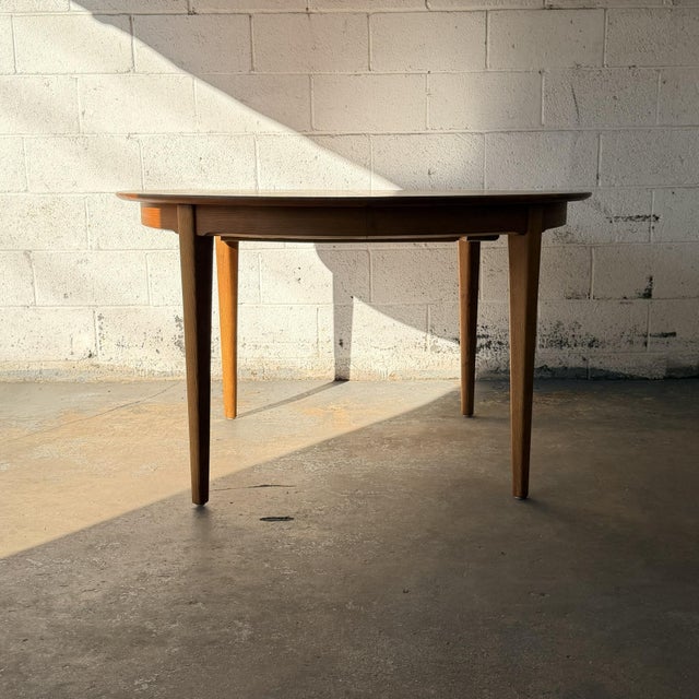 A monumental Model 62 extension dining table designed by Henning Kjærnulf for Sorø Stolefabrik, Denmark. This example...