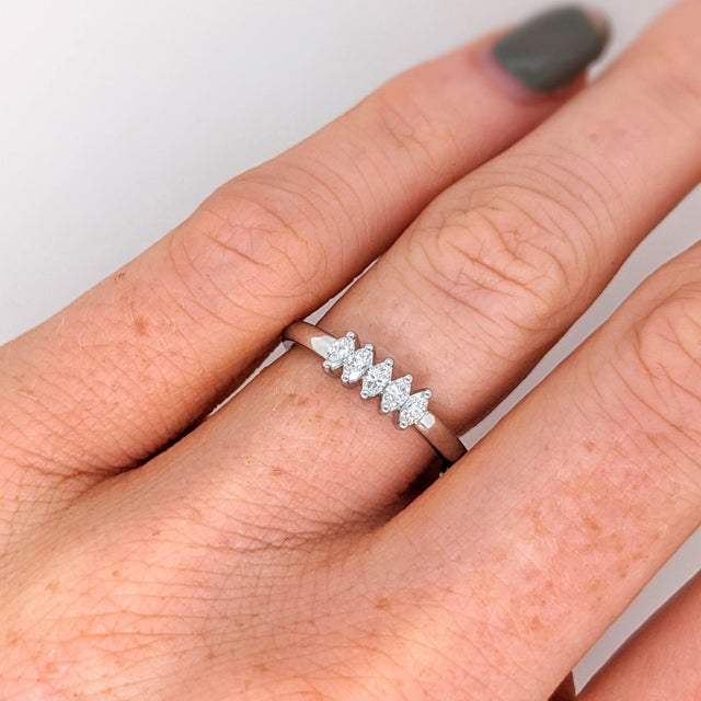 Five earth-mined diamonds run across this solid 14K white gold band. The hardest natural material, diamond has symbolised...