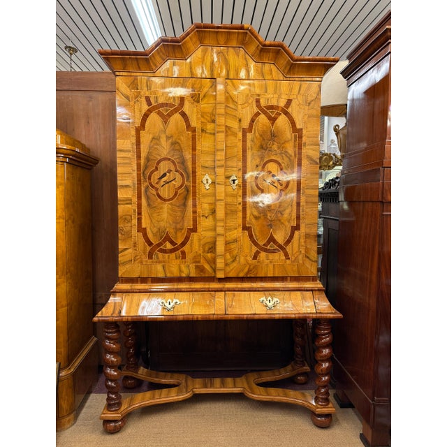 This magnificent Baroque cabinet is an exceptional example of 18th-century German craftsmanship, showcasing the elaborate...