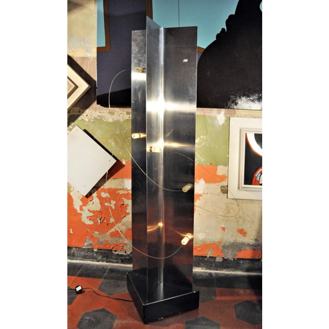 This is a model B.T.4 floor lamp made of lacquered wood, steel, and acrylic glass. It was designed by Group Designer...